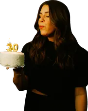 Woman blowing out a candle on her birthday cake