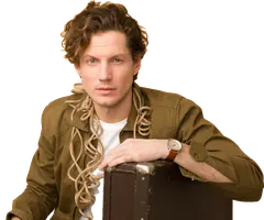 Young man sitting with a suitcase, moving in